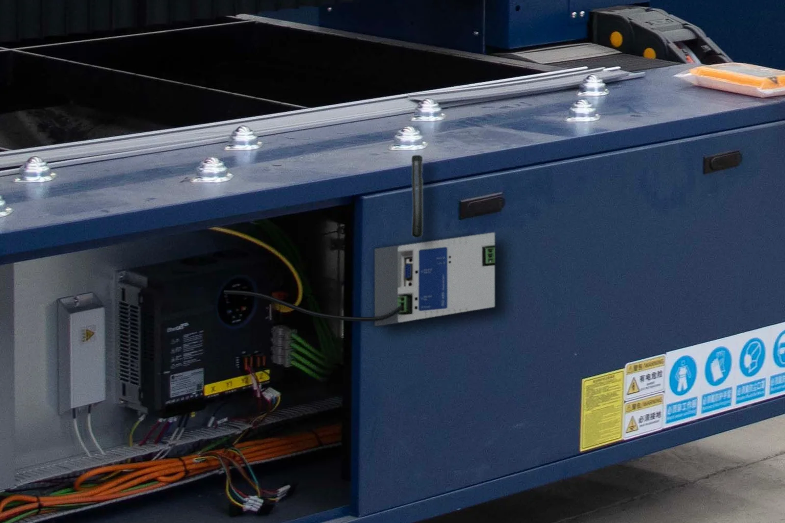 RD-485 monté sur la porte de l'armoire électrique d'une machine de découpe laser, câble RS485 vers le contrôleur de la machine, antenne orientée vers le haut pour la remontée sans fil
