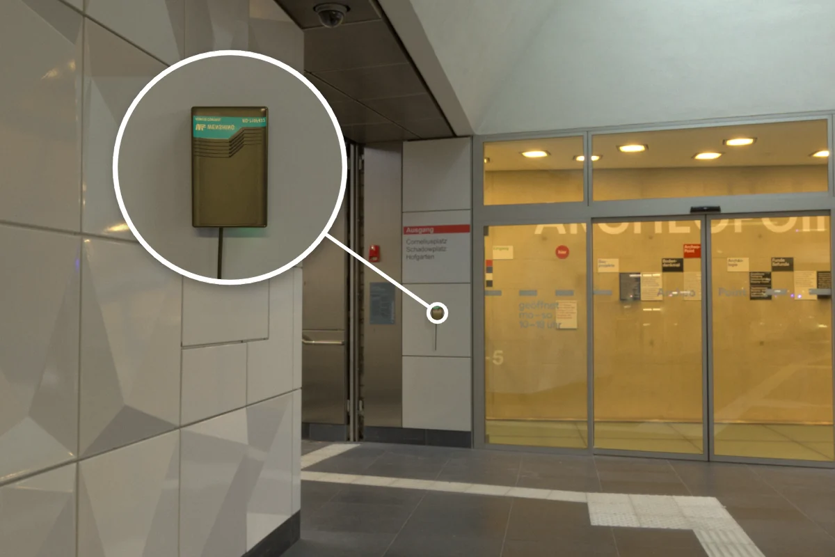 Glass automatic door with RD-710F-433 rolling door remote controller on the wall beside it for remote door opening