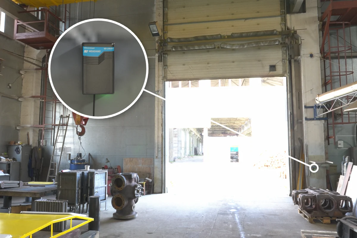 Factory entrance sectional door with RD-710F-433 rolling door remote controller on the column, opened by remote from the forklift