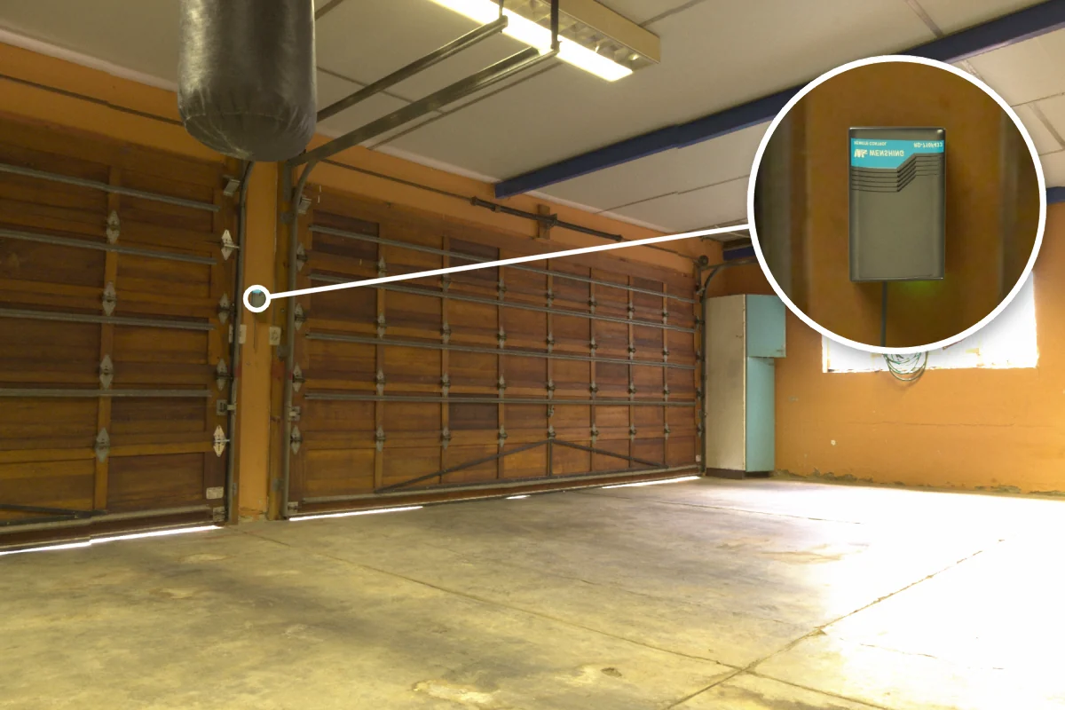 Warehouse roller shutter with RD-710F-433 rolling door remote controller on the wall beside it for remote up/stop/down